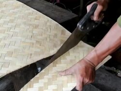 man sawing bamboo plywood sheet Stock Footage