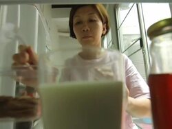 women open refrigerator  look for drink Stock Footage