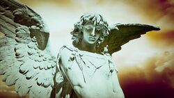 The statue of an Angel on time lapse clouds (Loop). Stock Footage