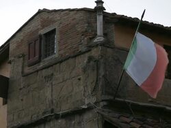 MH LA LD Italian Flag Waving Outside Old Building / Florence, Italy Stock Footage