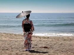 Japanese woman standing on the beach Stock Footage