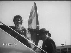 1953: IDLEWILD AIRPORT: VS People boarding aircraft, walking up aircraft steps, TU MS Unidentified aircraft propeller turning, boy leaning on gate (looking right), UNDER wing of Lockheed Super Constellation aircraft taxiing, WS Taking off, flying away Instructional Video