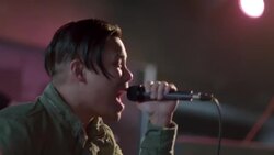 Passionate rock star sings into microphone and reaches hand out to crowd during Austin music festival Stock Footage