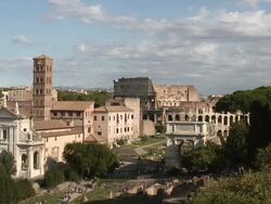 HA The Roman Forum with the Coliseum in the background / Rome, Lazio, Italy Stock Footage