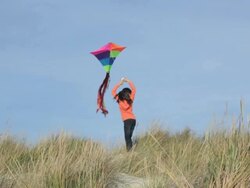 WS Young Girl Flying Kite on Beach Dunes / Eastville, Virginia, USA Stock Footage
