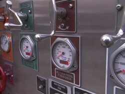 Digital readouts show on a control panel covered with levers and dials. Stock Footage