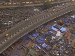 WS AERIAL DS View of rubbish dump with blue container and bridge / Lagos, Nigeria Stock Footage