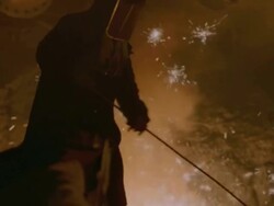 MS PAN Shot of Person in protective clothing tending to blast furnace Stock Footage