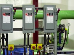 Some electrical boxes in front of pipes and gauges Stock Footage