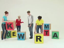 Four people using blocks to spell teamwork, time lapse Stock Footage