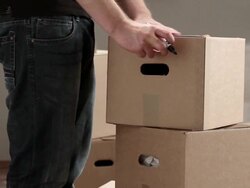 MS PAN Man taping box and writing kitchen on it / Berlin, Germany Stock Footage