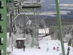 WS View of skier and snowboarder on piste, winter sport, and snow ski lift / Erbeskopf, Hunsruck, Rhineland Palatinate, Germany Stock Footage