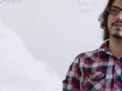 MS TU PAN R/F young businessman sitting in discussion at workstation in high tech office Stock Footage