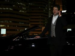 MS TU Well dressed young man standing next to his modern convertible car with confidence at night in urban area / Minneapolis, Minnesota, United States Stock Footage