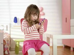 HD DOLLY: Little Girl Using A Mobile Phone Stock Footage