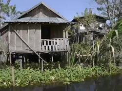 MS POV View of Boat riding along floating village / Ywama, Shan State, Myanmar Stock Footage