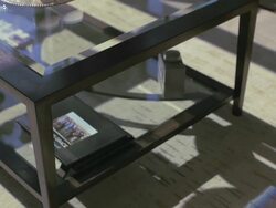 Focus on glass top coffee table, patterns of sunlight move across floor. Stock Footage