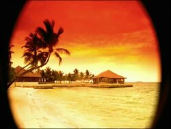 POV binoculars looking at beach hut at sunset Stock Footage