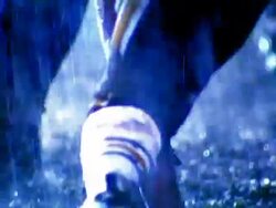 OVEREXPOSED close up football player snaps ball into play, opposing players try to tackle runner / rain Stock Footage