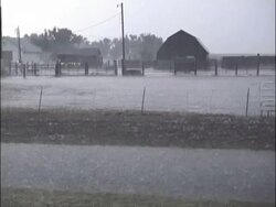 MS Farm building and fields pounded by torrential hailstorm, lightning flashes, USA Stock Footage