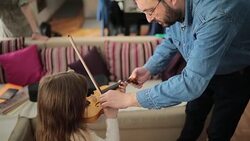 Father and daughter violin lesson Stock Footage