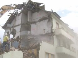 MS Demolition of apartment block and man watering / Saarburg, Rhineland-Palatinate, Germany Stock Footage