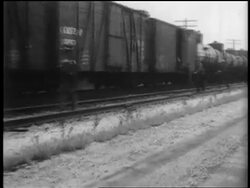 B/W 1935 men running alongside + jumping into slowly moving train Stock Footage