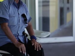 Senior man in cowboy hat sitting in front of store and waiting Stock Footage