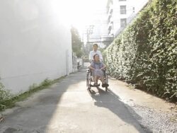 Young caregiver take care elderly woman on wheelchair Stock Footage