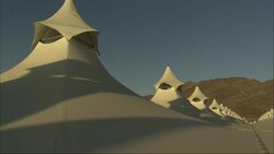 A gray sky outlines the peaks of pavilion canopy in Saudi Arabia. Stock Footage