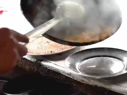 Short film showing preparation of Indian cuisine and people eating Stock Footage