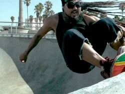 MS SLO MO Shot of skateboarder riding up out of bowl, grinding, and riding back down / Venice, California, United States Stock Footage