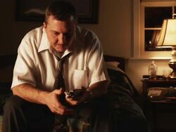 depressed man sitting and holding a handgun to his head Stock Footage