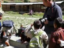 Professional Photographer talking to young children on there way to school, Bhutan, Asia Stock Footage