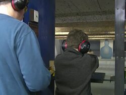 Father Teaches Son to Shoot a Handgun Stock Footage