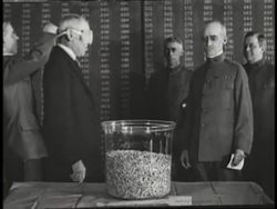 President Woodrow Wilson picks a number from jar for the draft while blindfolded. News Clip