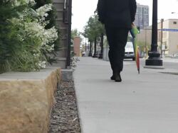 MS Young man dressed up in black suit and walking on street / Minneapolis, Minnesota, United States Stock Footage