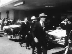 B/W 1963 policemen standing outside of hospital / Kennedy assassination / Dallas Stock Footage