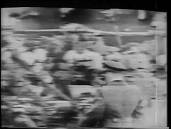 B/W 1961 Yuri Gagarin in uniform approaching Nikita Khrushchev on platform after flight / on TV Stock Footage