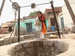 Woman taking out water from well, Faridabad, Haryana, India  Stock Footage