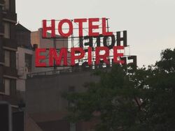 The Hotel Empire neon sign at dusk Stock Footage