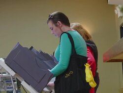 MS Shot of young white middle-class woman votes in presidential election at union hall / Toledo, Ohio, United States Stock Footage