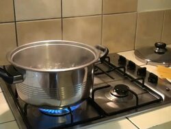 Woman's hands putting spaghetti in the boiling water Stock Footage
