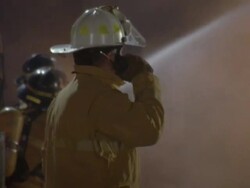 WS TS ZI Firemen working on burning building and fire trucks / Unspecified Stock Footage