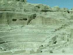 Petra archaeological site and amphitheatre, pan away to rocky desert surrounds, Jordan Stock Footage