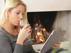 Female in front of fireplace looking at digital tablet Stock Footage
