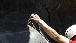 Detail of a young man rock climbing and grabbing a hold. Stock Footage