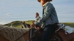 Female ranchers talking on horseback Stock Footage