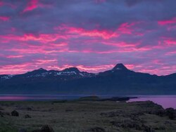 Timelapse of sunset light hitting clouds next to the ocean in Eastern Iceland during midnight sun. Stock Footage