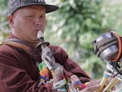 Hmong man playing the saxophone invented by himself. Stock Footage